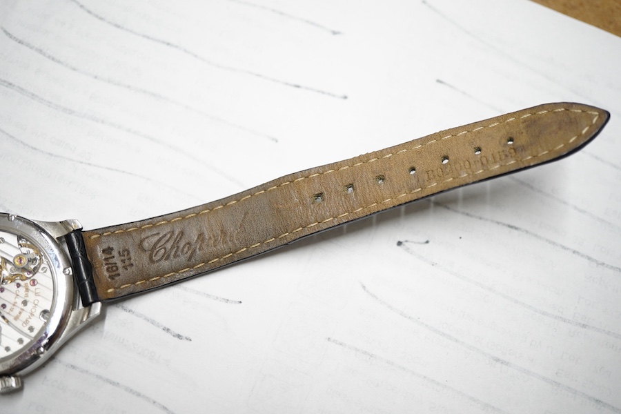 A gentleman's recent 18k white metal L.U. Chopard automatic chronometer wrist watch, with mother of pearl dial, diamond dot markers and subsidiary seconds, the bezel set with small brilliants, case diameter 35mm, movemen